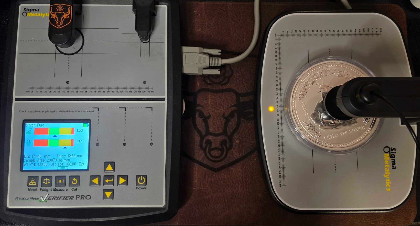BPM’s Sigma Metalytics Pro and external bridge checking a silver bullion piece in a clear capsule